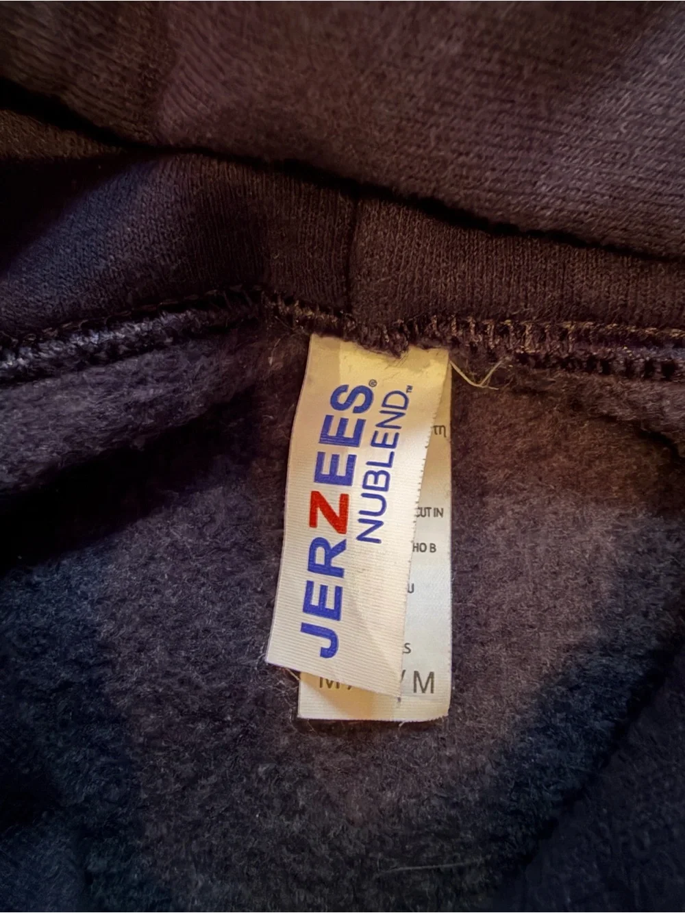 Jerzees Black Hoodie with White 'Don't Trip Over What's Behind You' Graphic